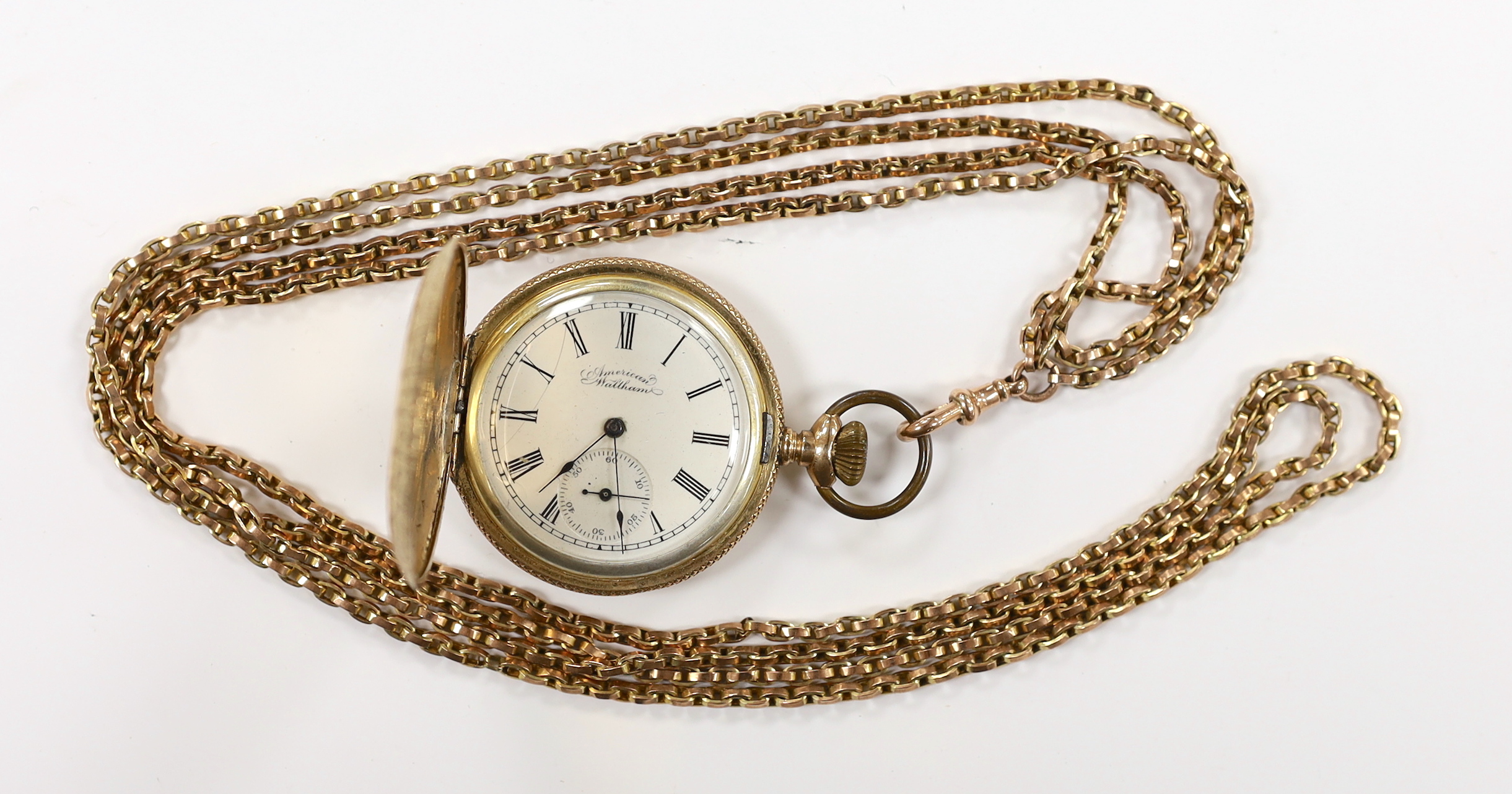 An American Waltham engraved gold plated hunter pocket watch, case diameter 42mm, together with a 9ct double strand chain, 39cm, chain 29.6 grams.